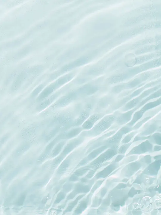 Sunlight rippling across the surface of clear water